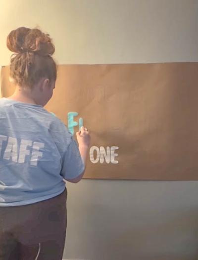 Hallahan creating one of her banners.