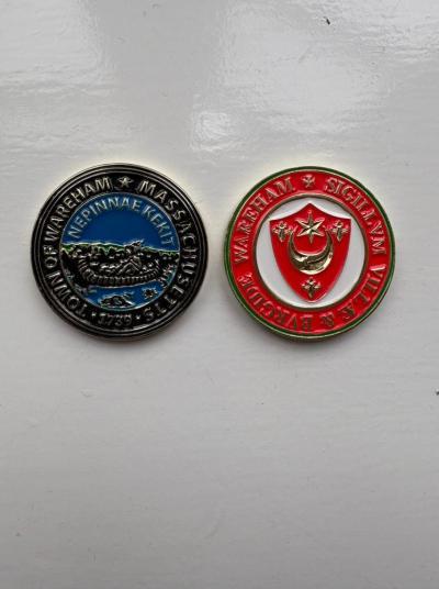 The coins Claire Smith presented with Wareham, MA's town seal and Wareham, U.K.’s town seal. File photo