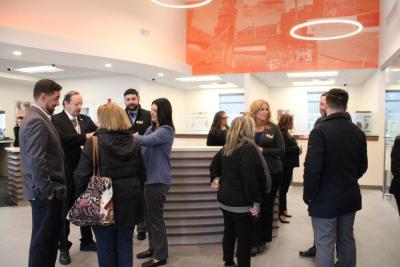 Many mingle before the ceremony with the mural behind them.