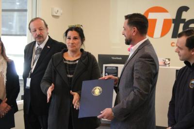 Nelson Tavares receives a citation of support from Senator Kelly Dooner's office. 