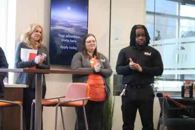 Bank members clap following the cutting.