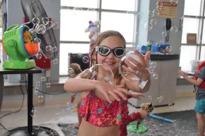 Grace, 7, shows off some bubbles she caught. Photos by Kat Sheridan