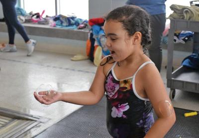 Isabele Wheeler, 5, is so happy she caught a bubble. 