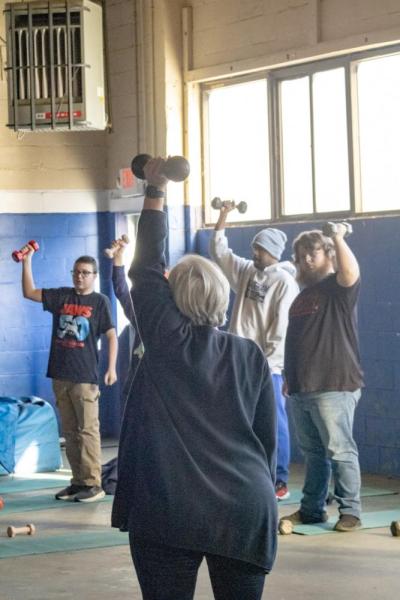 Marybeth Kiernan helping her students with proper form.