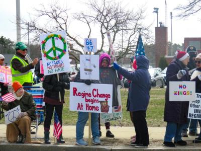 Protestors oppose Trump's presidency and call for peace. 