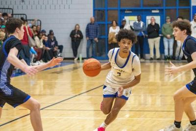 Malikhi Tavares drives the ball down court. 
