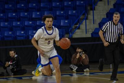 Moving fast, Amare Rose makes his way to the net.