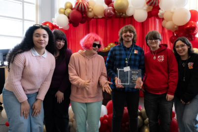 Adviser Joey Ferro holds the Rising Star Award with his students. Photo source: Plymouth Area Prevention