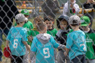 Two teeball teams showing good sportsmanship following their game.
