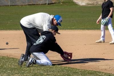Coach Cabe works with his players on low catches.