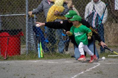 A player on the Dance Innovations VIP Teeball team bolts for first plate. Photos by Brandy Muz