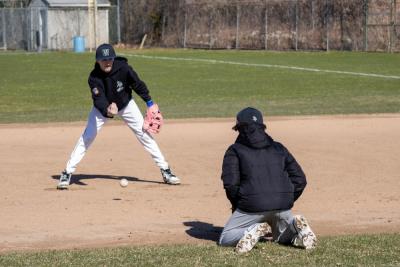 The players focus on catching the ball low.