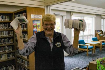 Town Clerk Lisa Johnson holding up the 'real' voting ballots for the town peep election. 