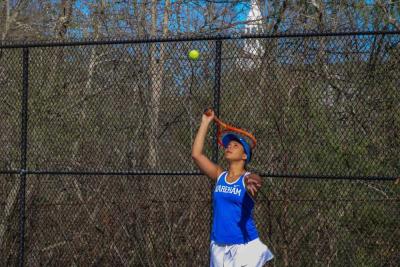  Julianna Frye serves during a home game against Old Rochester on May 1. Photos by Grace Roche