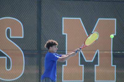 Thomas DeCanto hits it back to his opponent. 