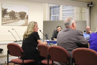 Jennifer McHugh sits next to Christian Consoletti during the meeting. 