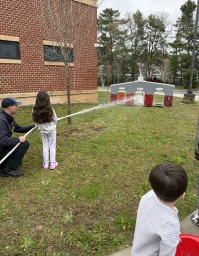 Fire! Students help put out fake fires with Wareham Fire Department.