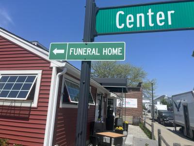 A sign in front of the Pour Farm Tavern points to the Wareham Village Funeral Home. Photos by Brandy Muz