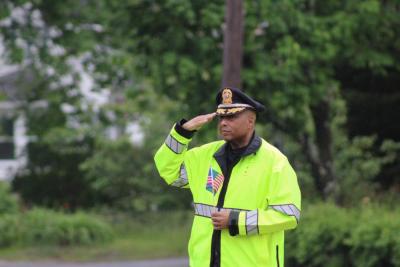 Wareham Police Chief Walter Correia salutes during the playing of Taps.