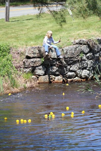 A spectator watches the ducks round the curve.