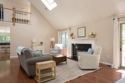 Living room with cathedral ceiling and wood burning fire place