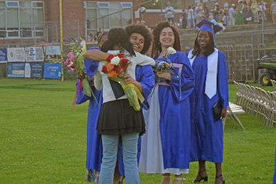 Graduates celebrate with their friend. 