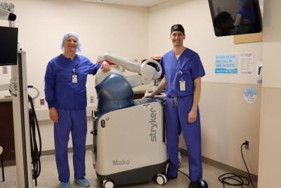 Dr. Christian Dee, left, and Dr. John Carroll show off the new robotic tech at Tobey Hospital. 