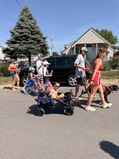 residents walk down the road for the parade