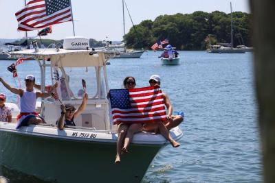 Two hold flag at front of boat