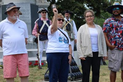 Claire Smith, center, rings a freedom bell. 