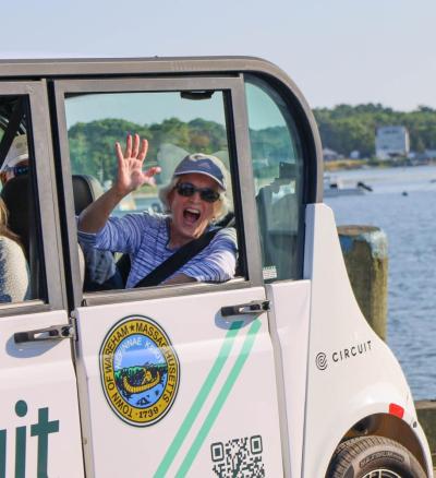 Karen Butler waves while taking a ride in the shuttle.