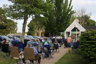 Residents pack the lawn outside the library for the concert.