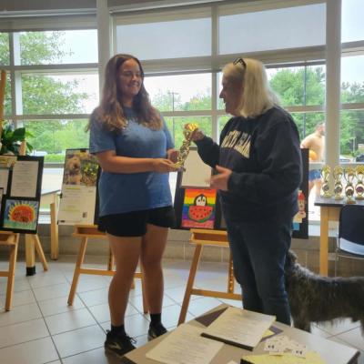Kailyn Ostiguy gets her trophy from contest organizer Sally Morrison.