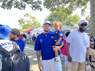 Mark Evora holds his son, Shilo, 1, who sports a Cape Verde soccer jersey. Photo by Christian Uva