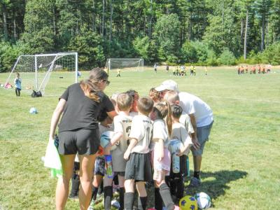 A team huddles after winning its first game of the year.