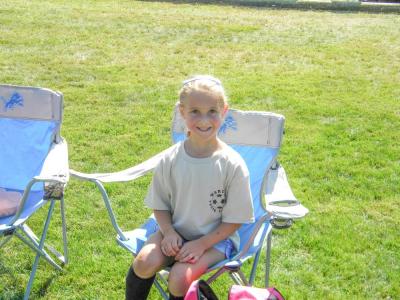 Scarlett Braley, 6, rests after her first game of the season.