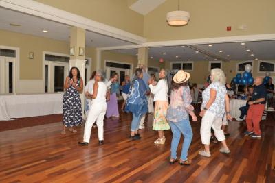 Classmates dance together.