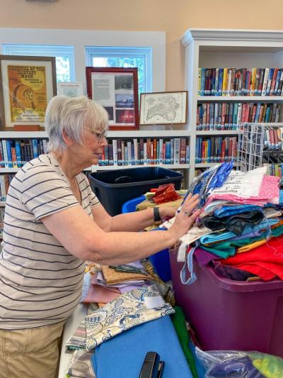Jane Haupt sorts through a growing mountain of fabrics.