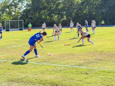 A field hockey player hits the ball during the 4-0 loss. Photo by Christian Uva