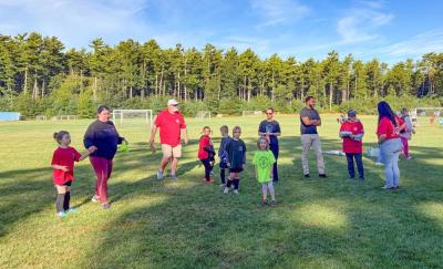 The Elks and Youth Soccer players gather around.