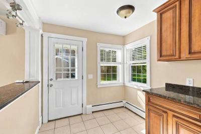 Kitchen with granite counters, a back door and two windows in the apartment at 17 Beeden Road, Westport, MA