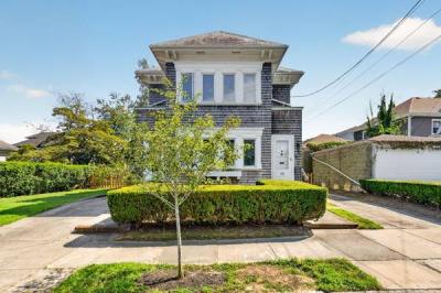 Street view of 370 Maple Street in New Bedford's West End, with its front walk and hedges