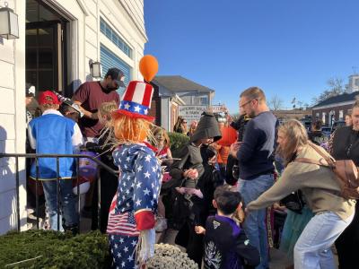 Trick or treaters stream out of a law office on Main Street. 