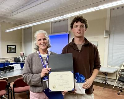 Superintendent Amy Hartley-Matteson presents Wareham High School senior Mark Deyoe with the Massachusetts Association of School Superintendents Certificate of Academic Excellence during the School Committee's Oct. 29 meeting. Photo by Erin Darling