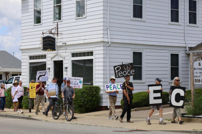 Wareham Faith in Action members hold signs during a June peace walk along Main St. File photo