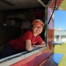 Lee leans outside her food truck.