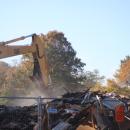 Dust settles as the home is leveled. Photo by Brandy Muz