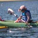 Cinnamon Roll the stuffed animal is strapped in for the ride.
