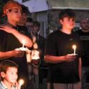 Amy Nadolny's eldest son, Kaiden Machado, second from left, listens to longtime friends of Nadolny share stories and speak on his mother's character and impact she has left on others.