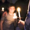 A candle burns during the vigil.